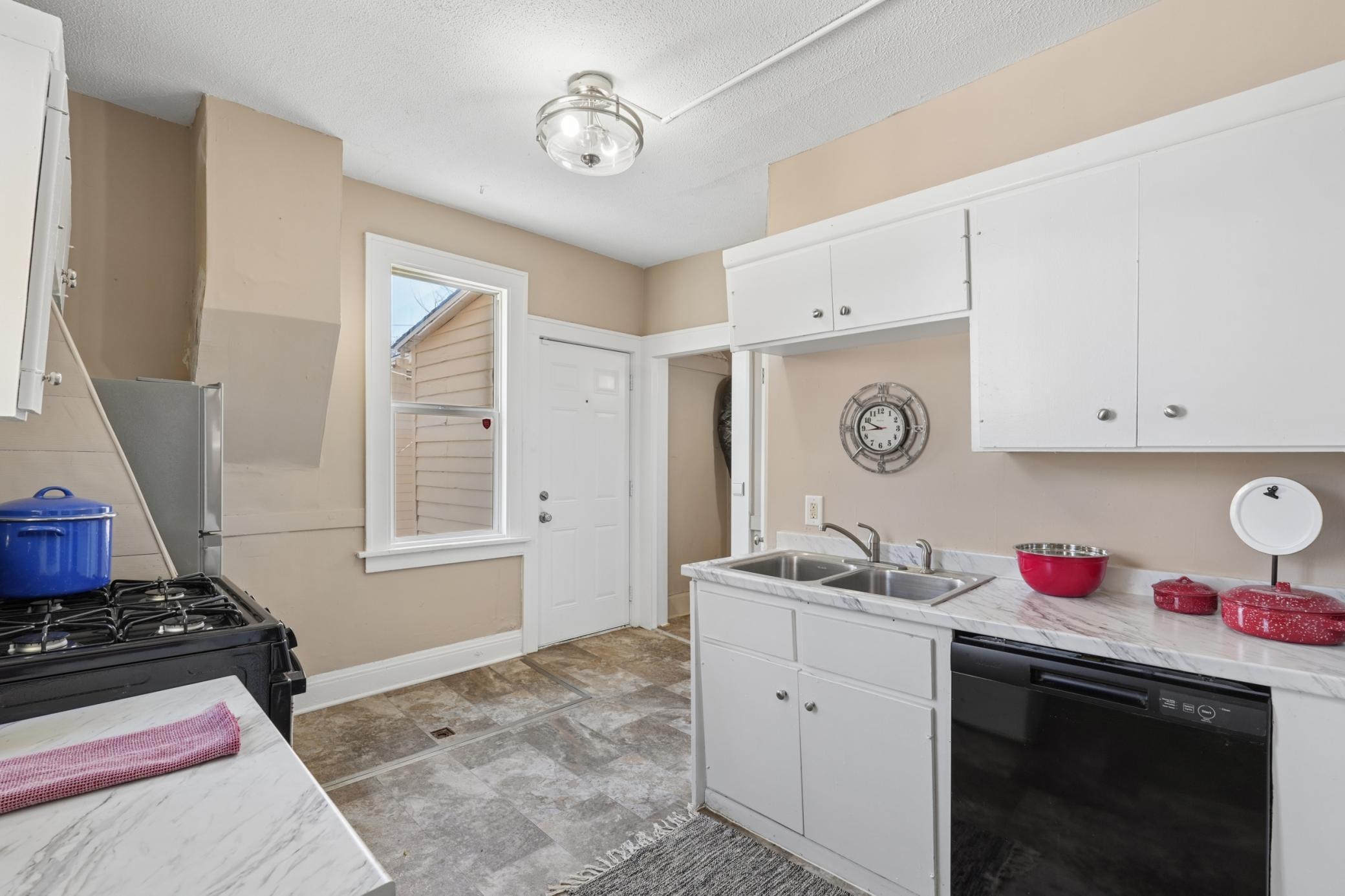 Kitchen view with double sink, updated surfaces, and convenient layout.