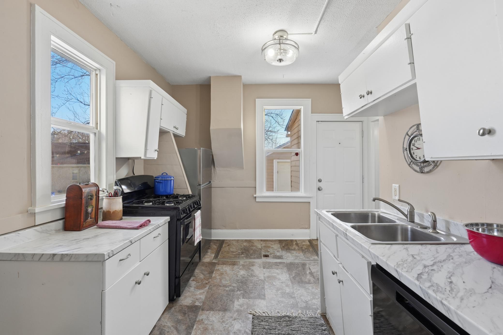 Updated kitchen featuring new countertops and ample cabinetry.
