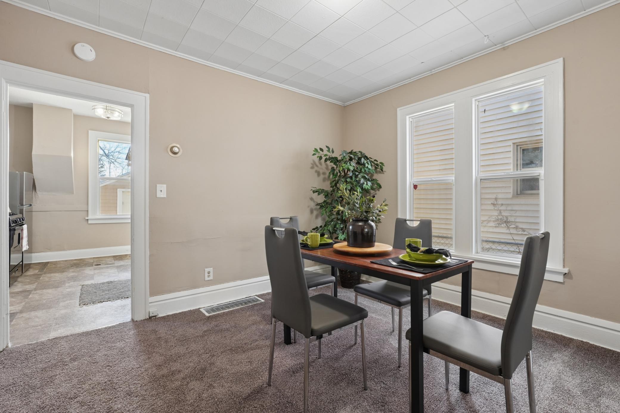 Dining area with new carpet and easy access to the kitchen.