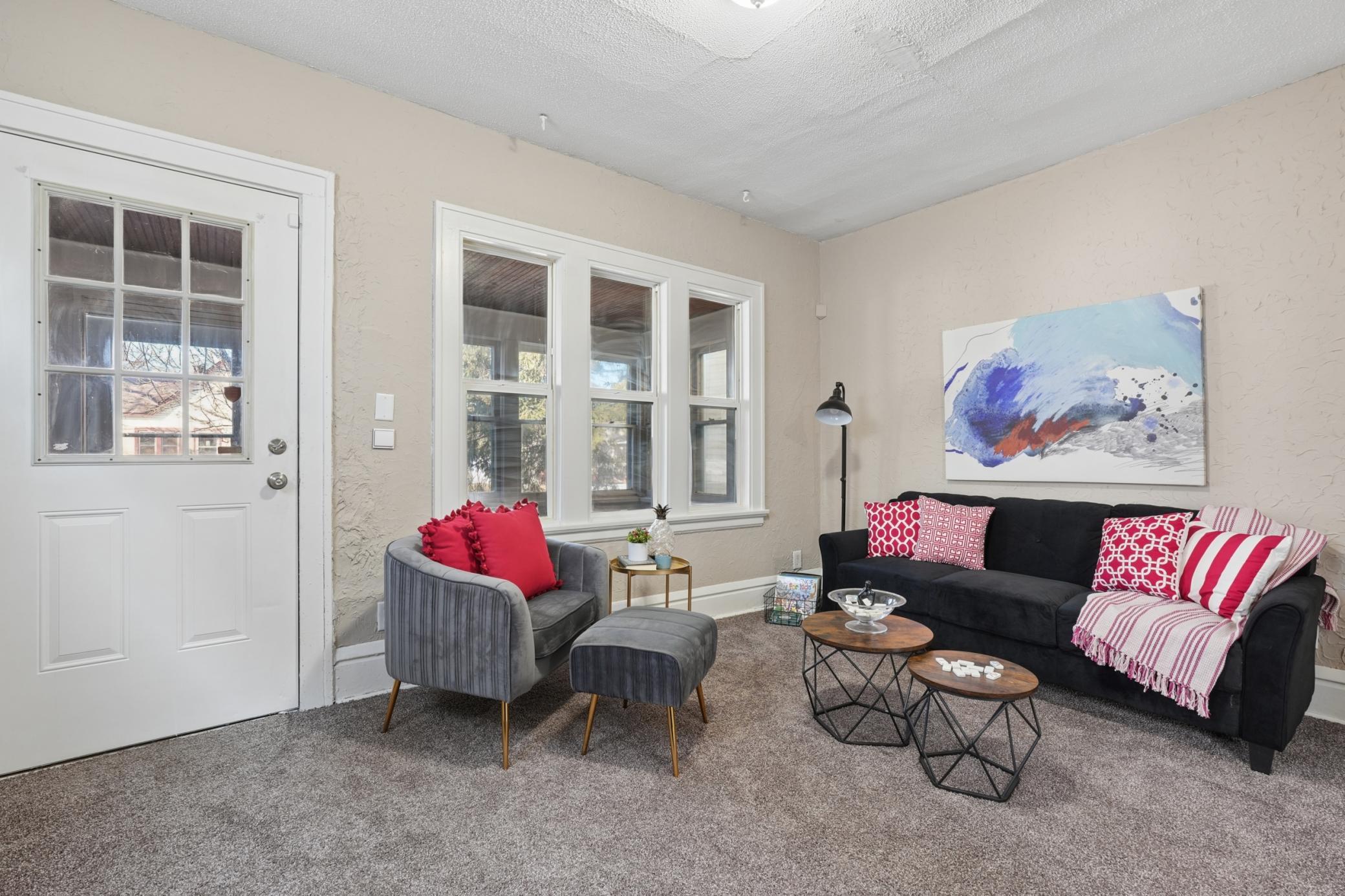 Spacious living room featuring fresh paint, new carpet, and beautiful cove ceilings.