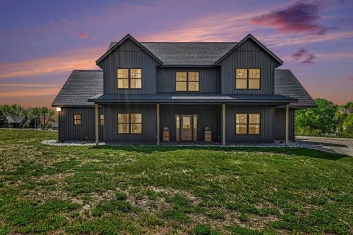 2023-built black modern farmhouse-style home with warm twilight curb appeal near Lake Volney in Le Center, Minnesota.