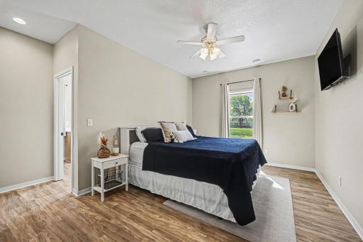 Primary bedroom with ceiling fan and LVP flooring â Le Center MN home for sale near Lake Volney, 4 bed 3 bath