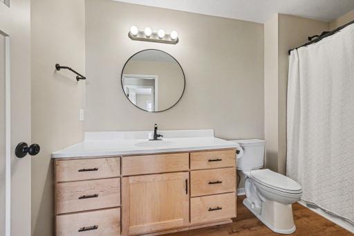 Upper full bath â round mirror, wood vanity, LVP â Le Center MN