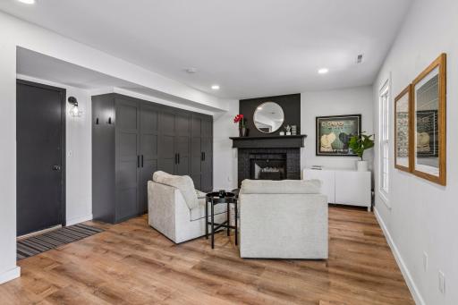 The family room is spacious and bright with a cozy fireplace with electric insert, built in storage cabinetry, a sliding door and window overlooking the sprawling fenced yard and direct access to the attached garage.