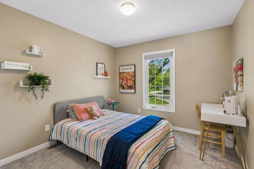There are three bedrooms on the upper level. The two secondary bedrooms both have overhead lights and plush carpet.