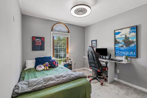 The third bedroom up has a fun sunburst style window, plush carpet and an updated overhead light.
