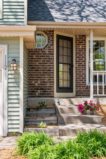 Welcome guests on your covered front porch. Theres even room for a couple of lounge chairs for relaxing next to the front perennial gardens.