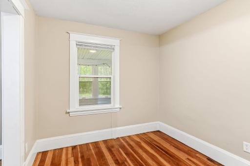 A bright main-level room that serves as a third bedroom. Ideal for creating a private retreat, guest room, or dedicated workspace.