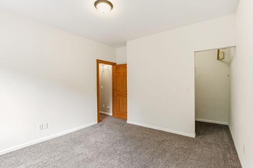 An inviting upper-level second bedroom with a practical layout and bright natural light.