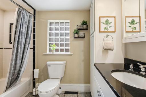 A beautifully updated full bath on the main level featuring fresh finishes, modern fixtures, and a bright, spotless look.