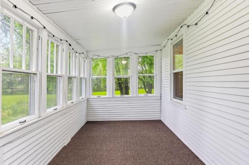 A spacious front porch designed for everyday living, with room for rocking chairs, plants, and more. Timeless farmhouse character.