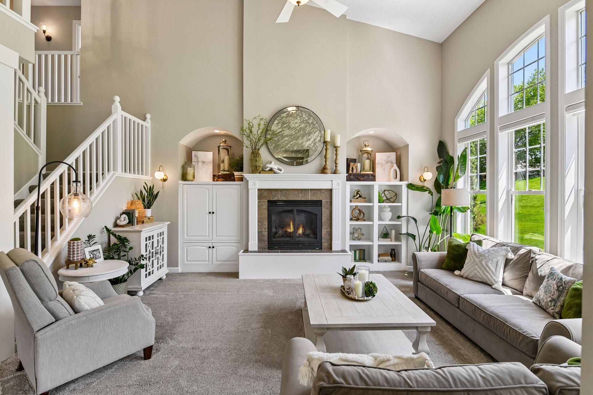 The two-story Great Room features a gas fireplace flanked by custom built-ins.