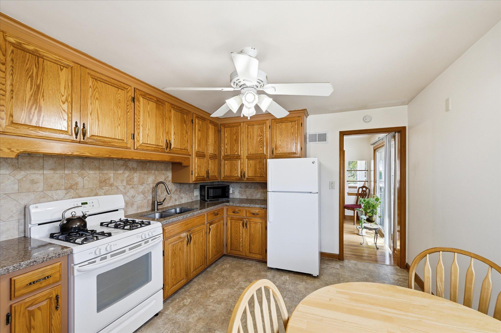 Gas stove. Granite counter tops. Ceramic tile backsplash