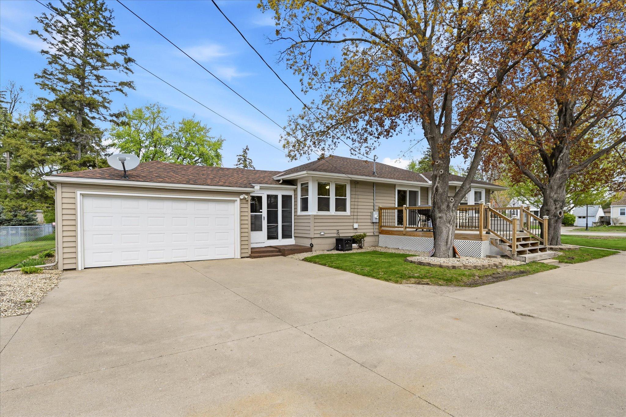 New roof on home and detached garage. Newer cement driveway and front sidewalk. 2 beautiful maple trees flank the deck for added shade