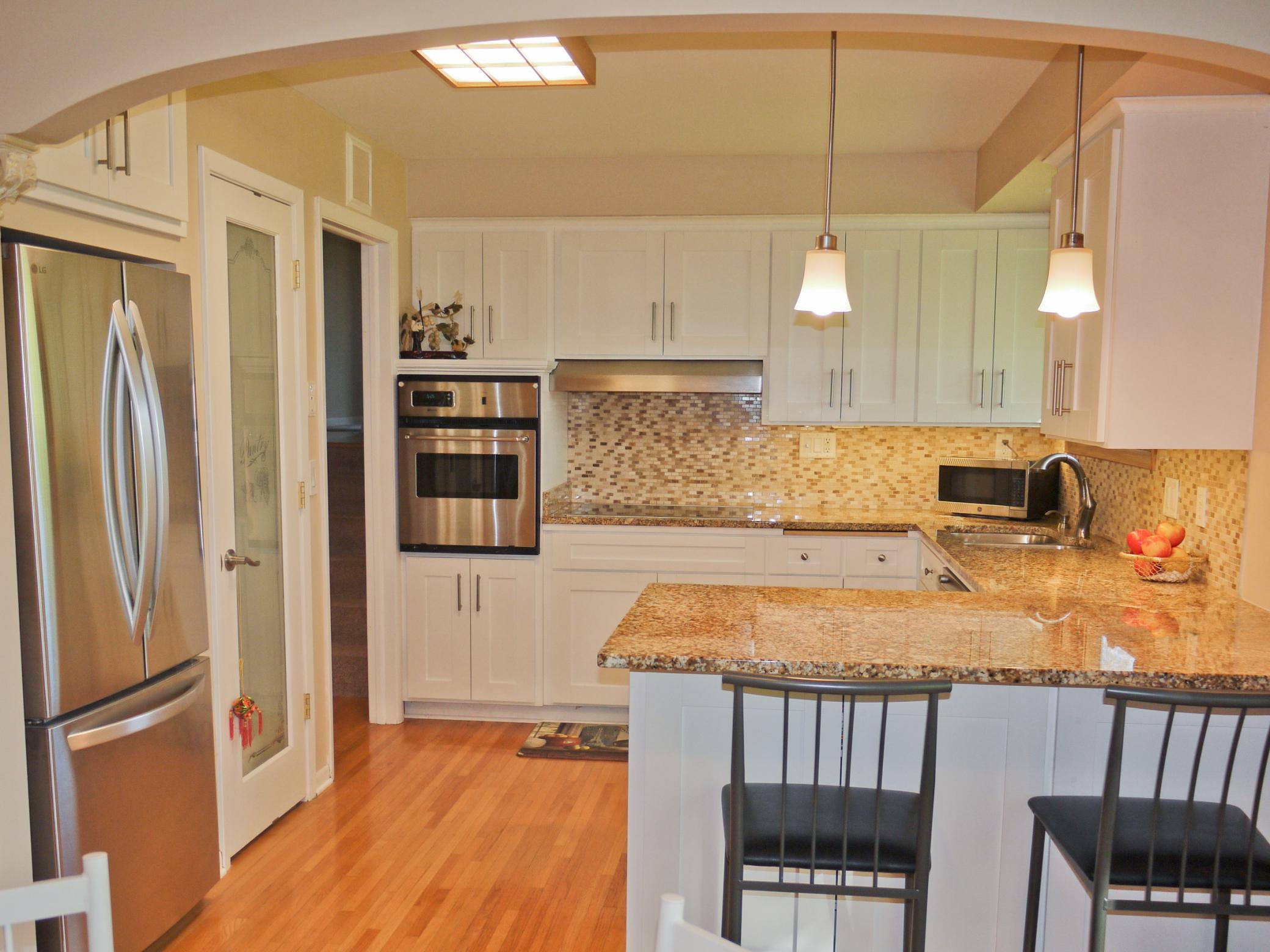 Kitchen area with refaced cabinets, granite countertops, new pantry and new stainless steel appliances.jpg
