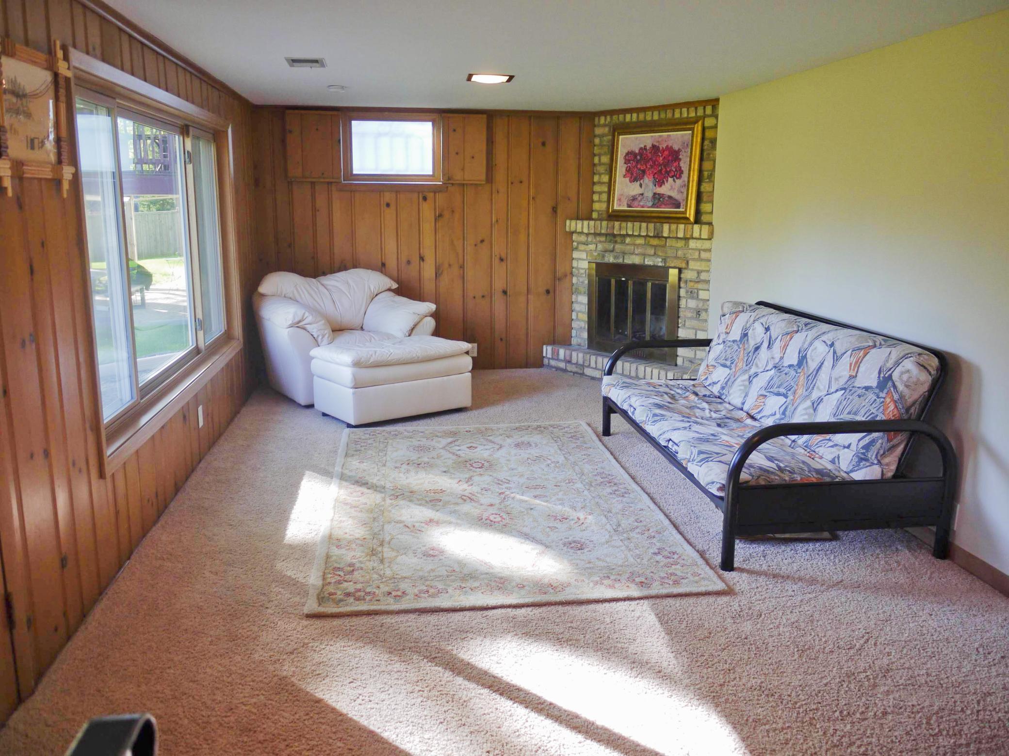 Lower level family room with full masonry fireplace and South facing picture window.jpg