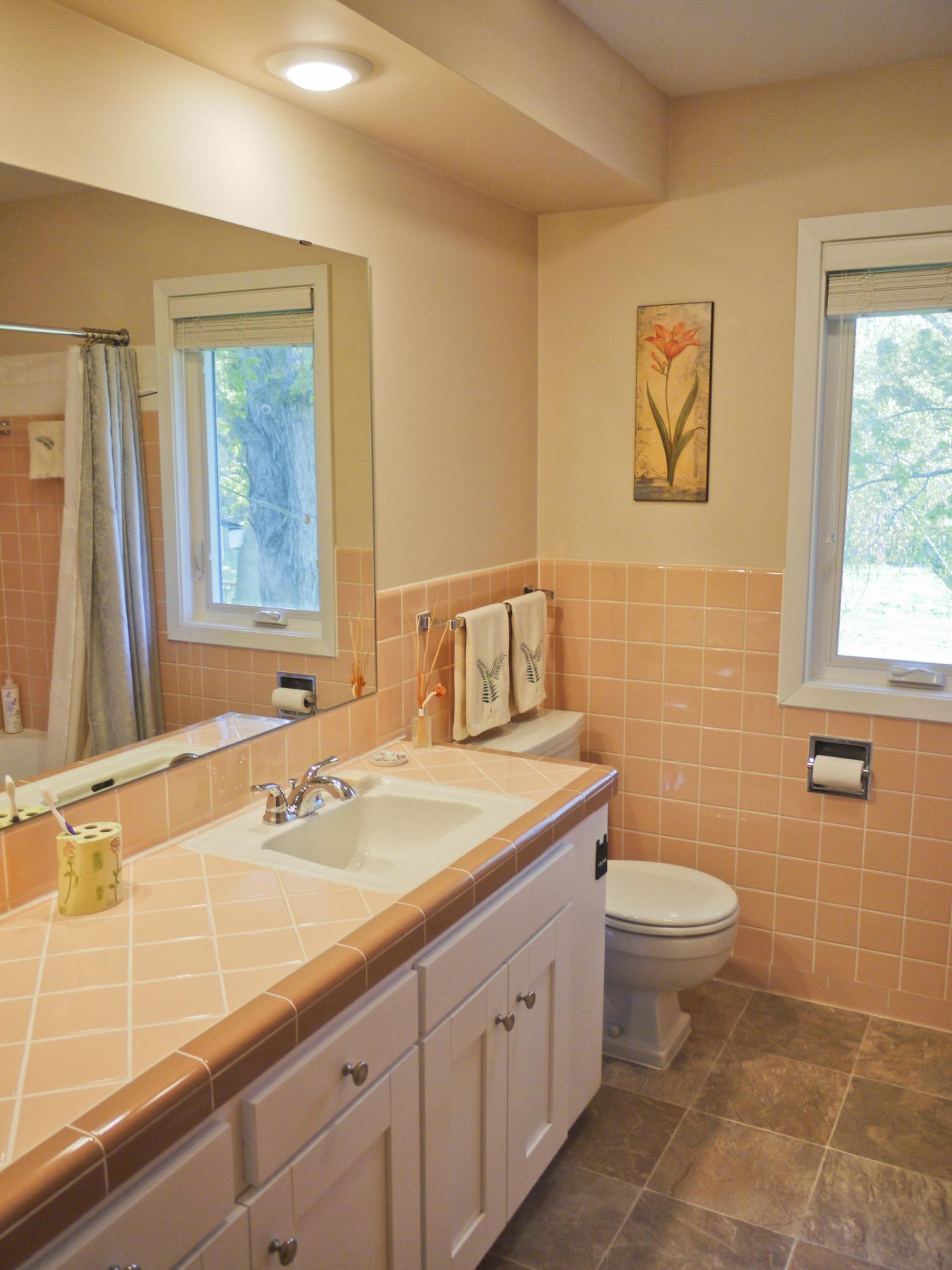 Bedroom level main bath with large vanity and new tile flooring.jpg