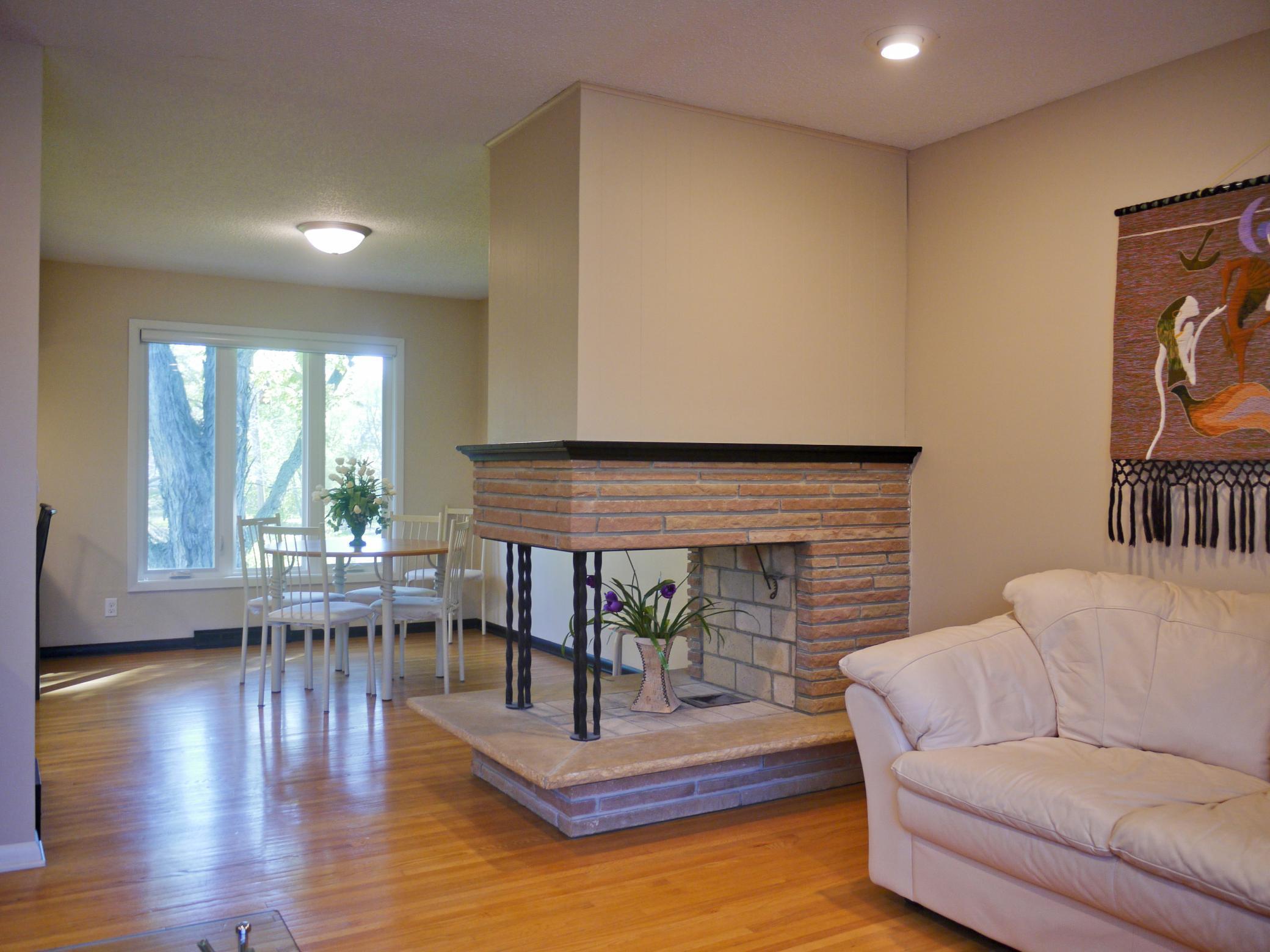 Entry to dining room showing 3 sided full masonry fireplace.jpg