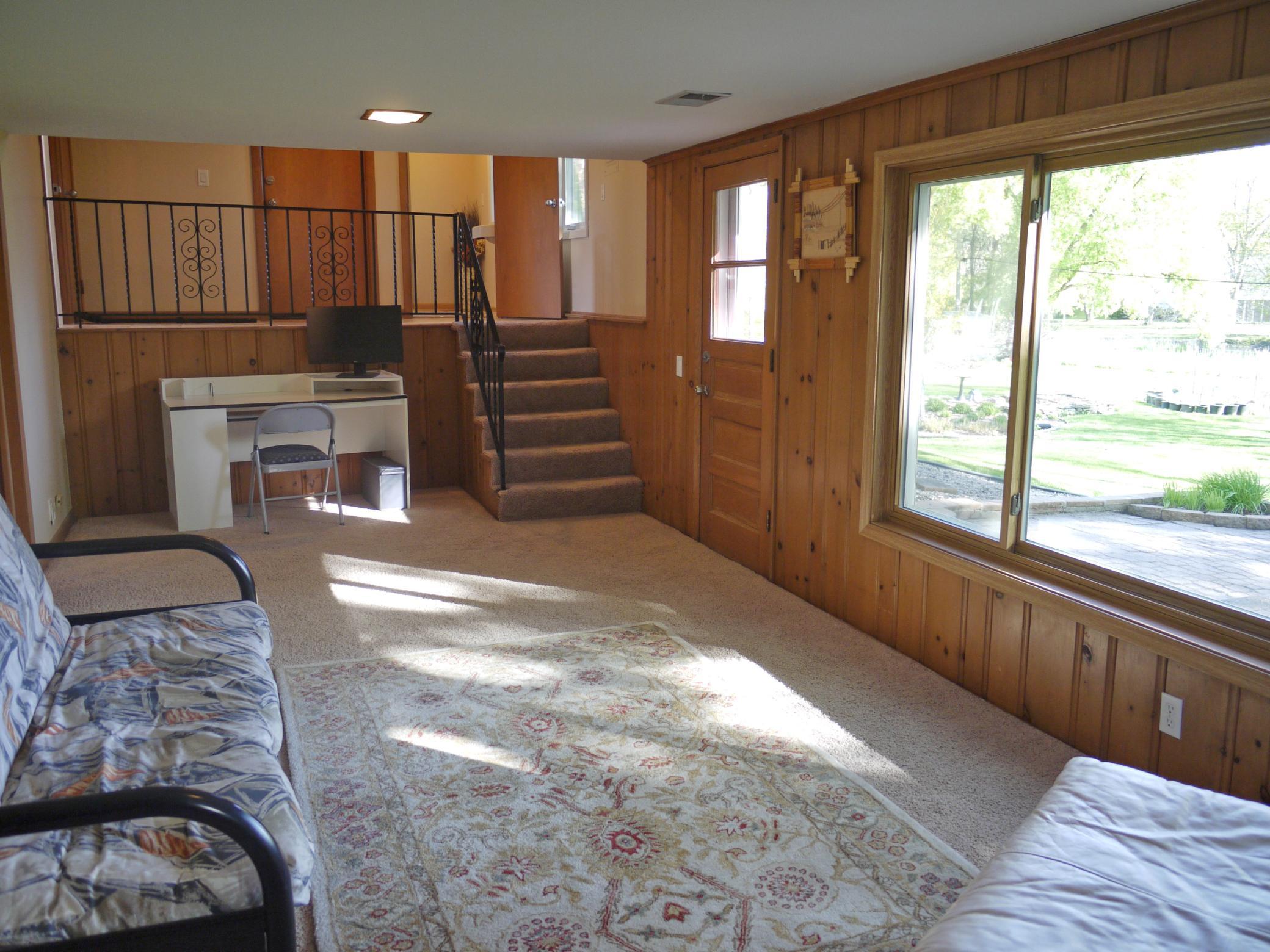 Reverse view of family room showing walk-out to patio area, study nook and stairs to entry level and half bath.jpg