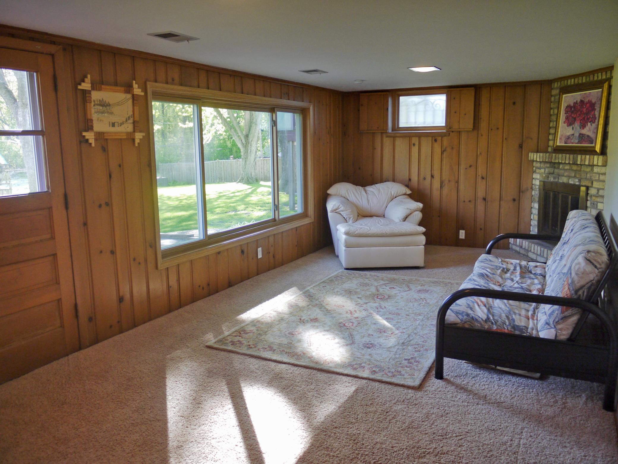 Cross view of lower level family room showing large picture window overlooking patio and yard.jpg