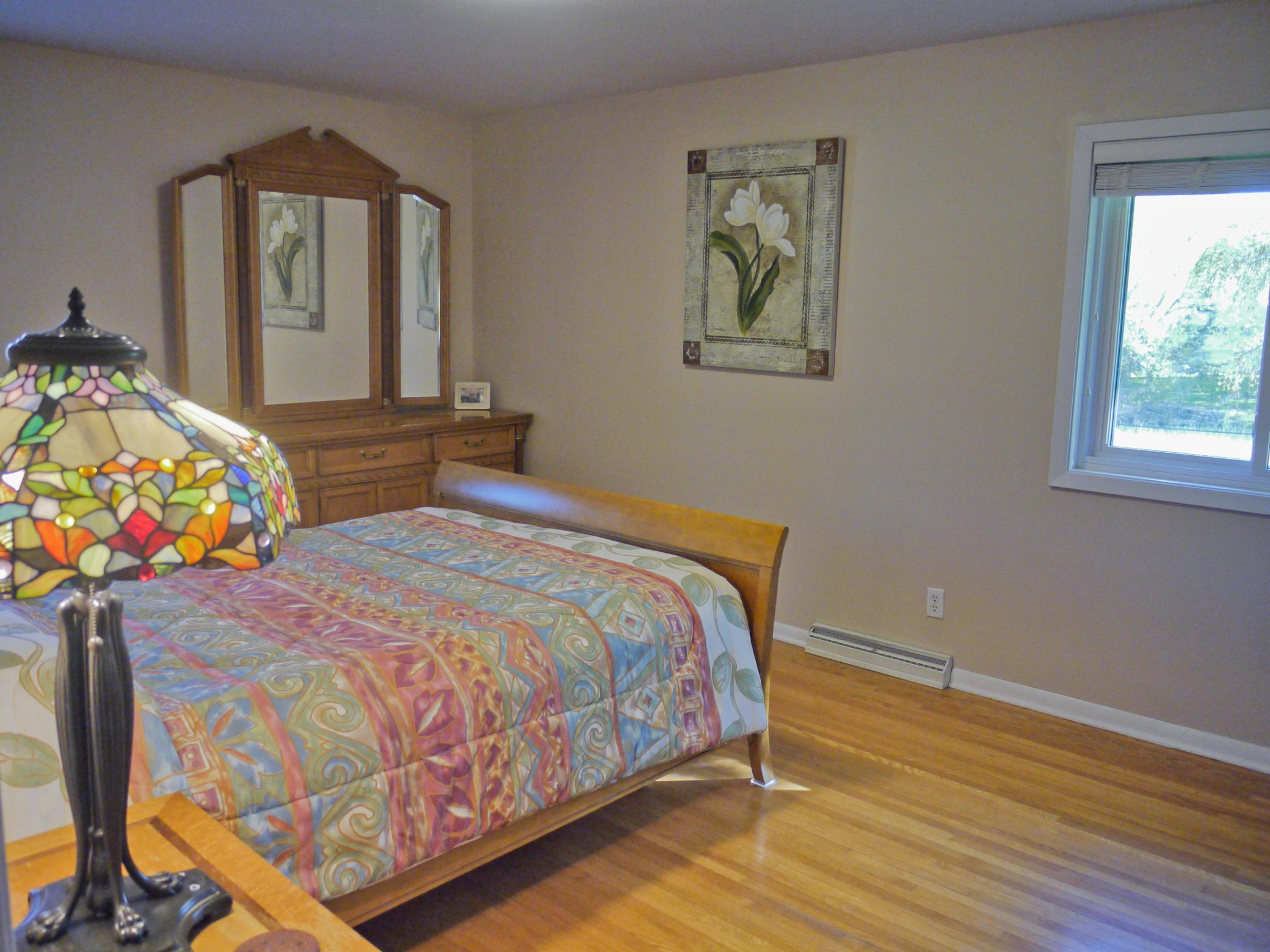 Owners suite with private, remodled 3_4 bath solid oak flooring, and South and East facing windows.jpg