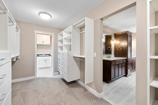 Primary walk in closet looking into bathroom