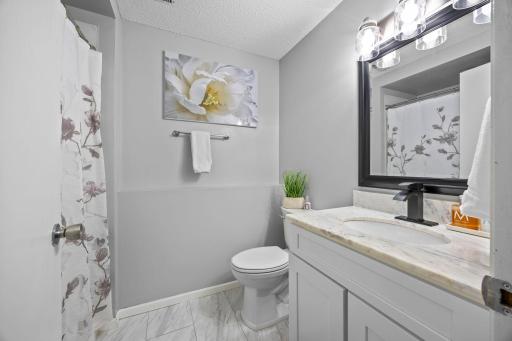 Neutral tones and a walk-in shower make this lower 3/4 bath feel polished and move-in ready.