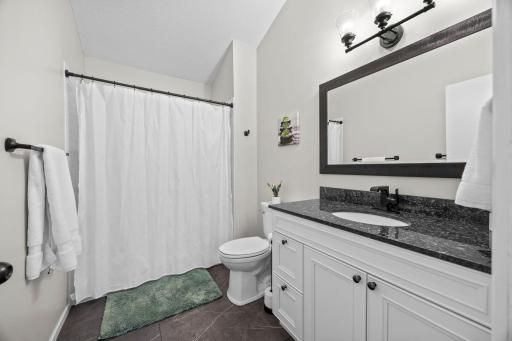 Updated in 2020, this full bathroom offers timeless neutral design ready for your personal touch.