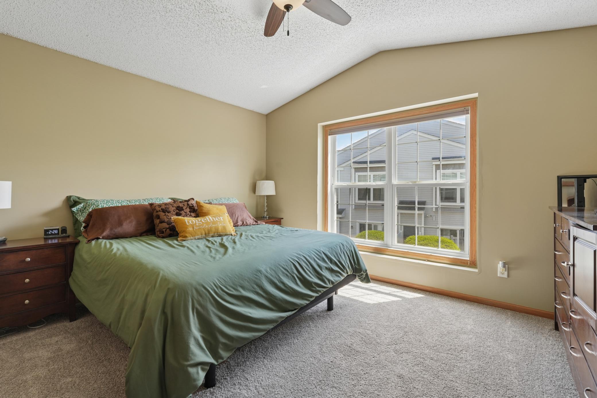 The upper level primary bedroom has wonderful space for a large bed and dressers