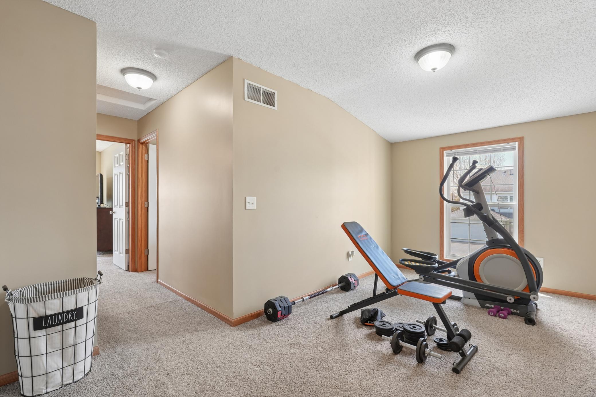 The bonus space in the loft is currently used as a workout area but has great potential as an office, den or whatever suits your needs