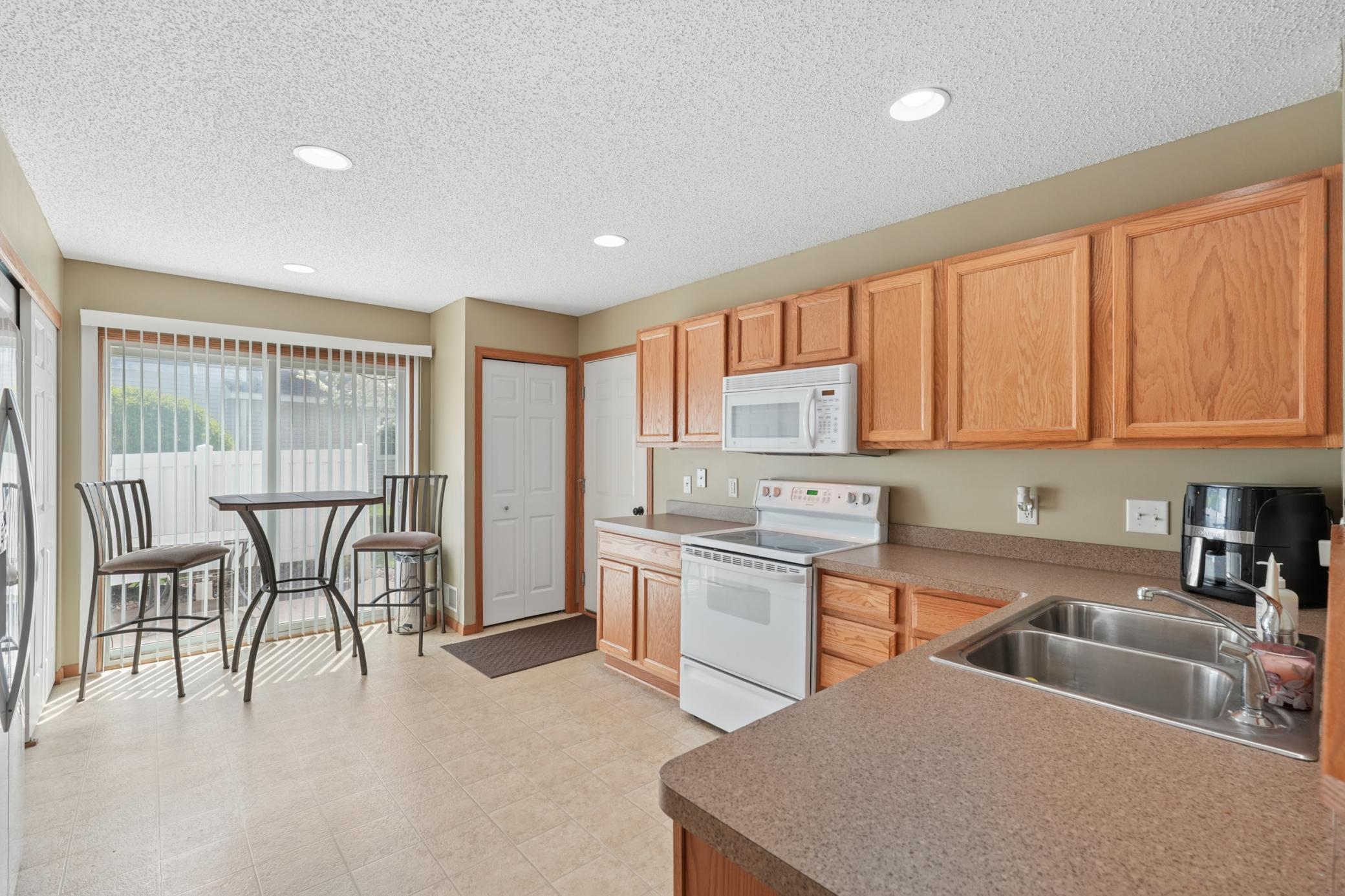 The kitchen has ample working & cabinet space while offering room for a bistro table.