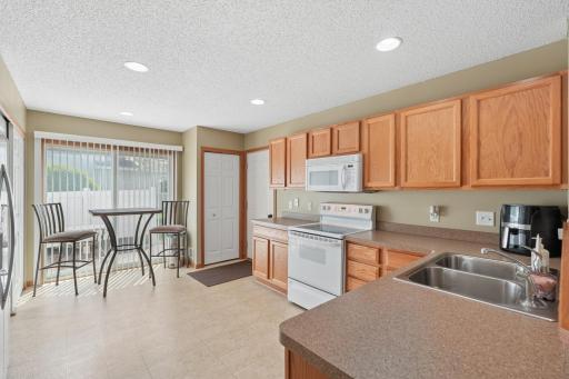 The kitchen has ample working & cabinet space while offering room for a bistro table.