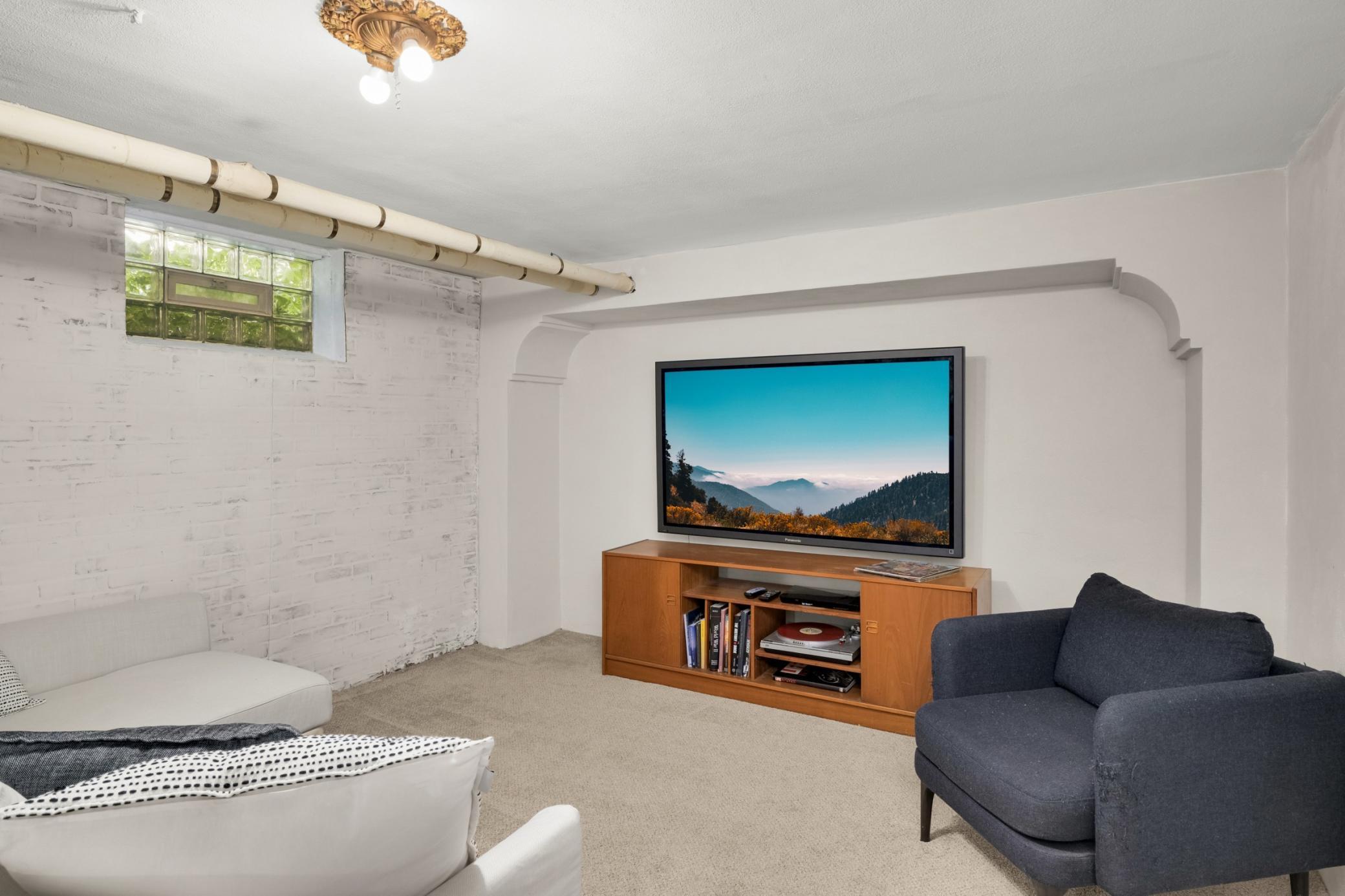 Great lower level retreat complete with plaster walls!
