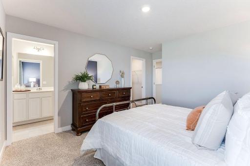 The primary bedroom suite overlooks the large backyard. (Model photo, colors may vary)