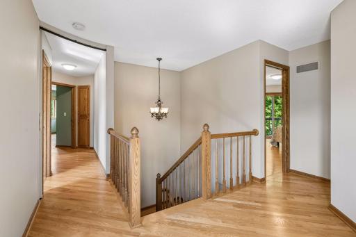 upper-level landing leading to bedrooms, bathroom, laundry and large storage closet
