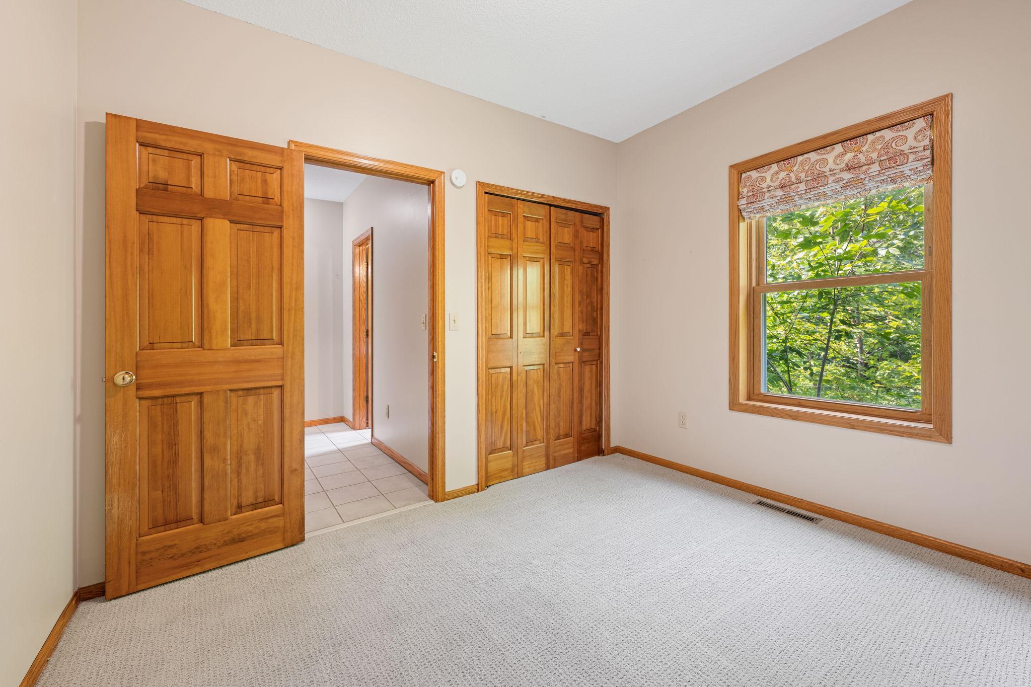 The main level bedroom is a private escape and perfect for a home office or hobby area!