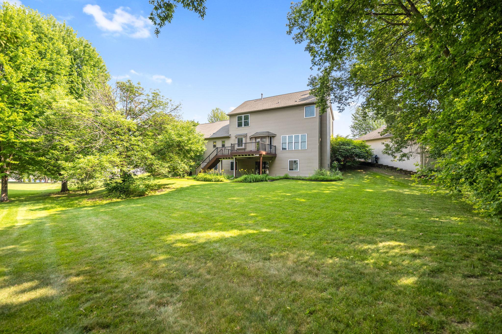 The large, flat back yard is surrounded by mature trees giving tons of privacy.