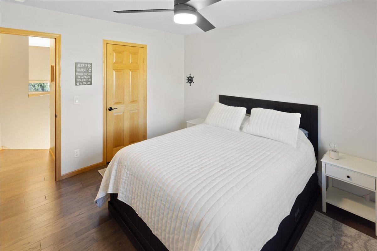 Updated Bedroom with Modern Ceiling Fan Upper level guest bedroom with walk in closet