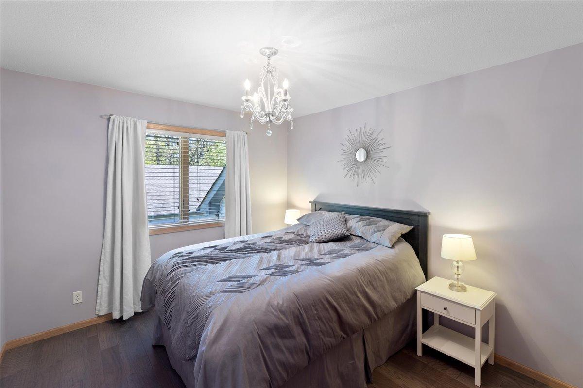 Comfortable Guest Bedroom with Stylish Chandelier 54-054.jpg