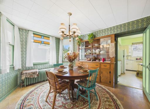 Formal dining room featuring built-in hutch and stained glass detail. virtually staged to show layout potential.