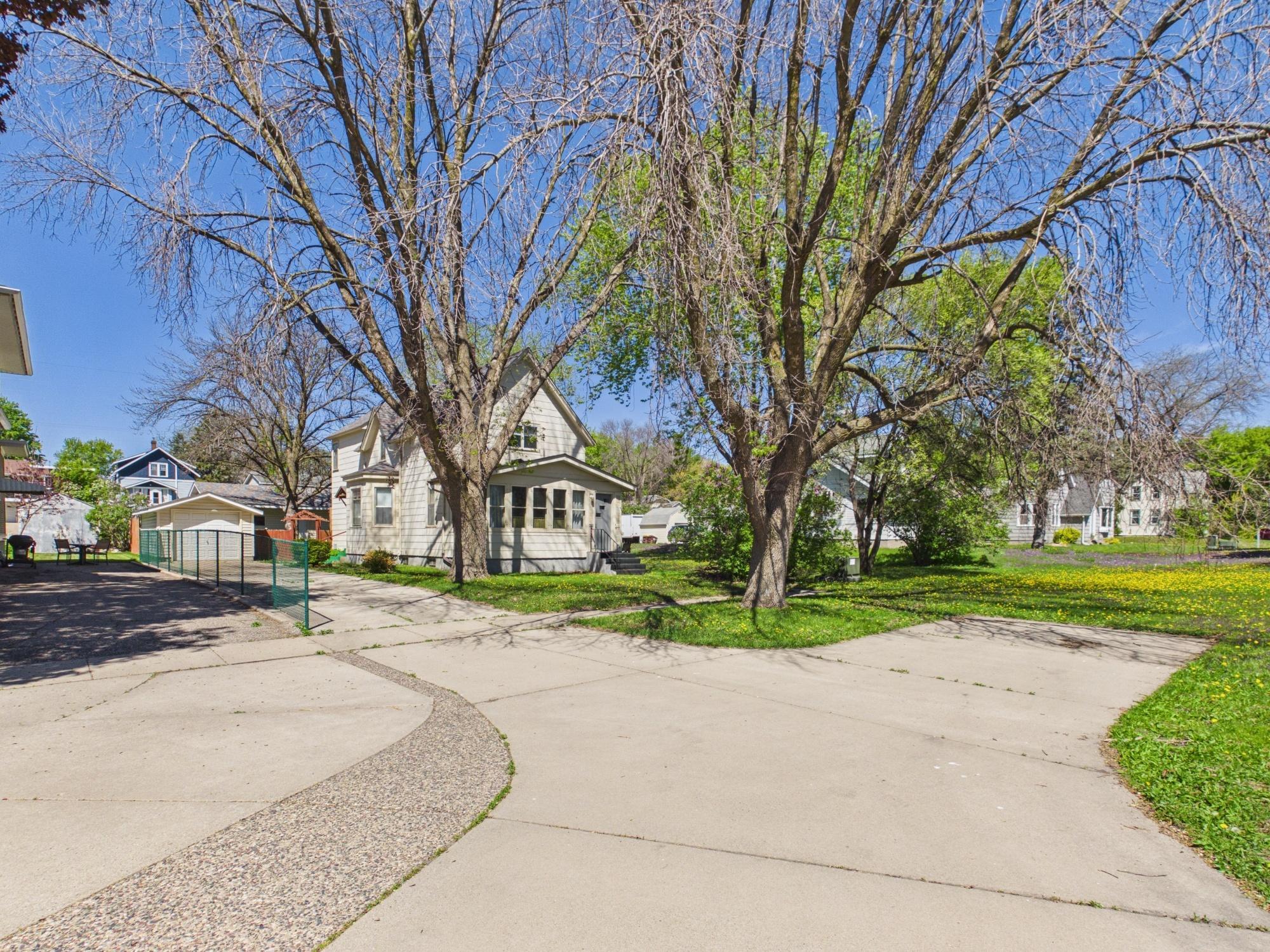 Exterior view showing mature trees and neighborhood setting.