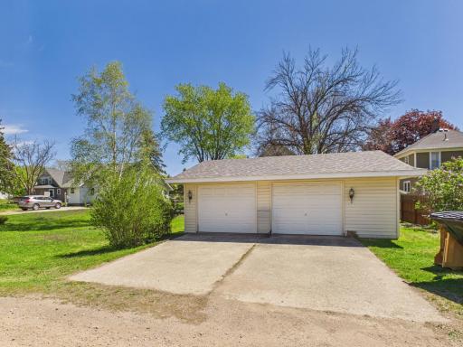 Large detached garage space with concrete driveway and extra parking.