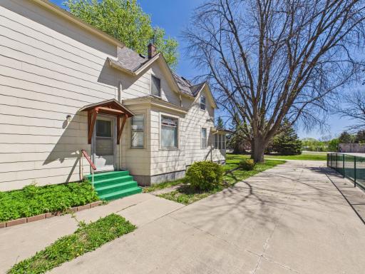 Side view of home with driveway, yard, and access.
