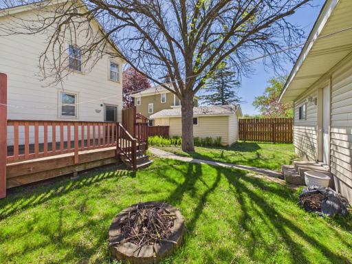 Backyard space with deck, lawn, and alley access.