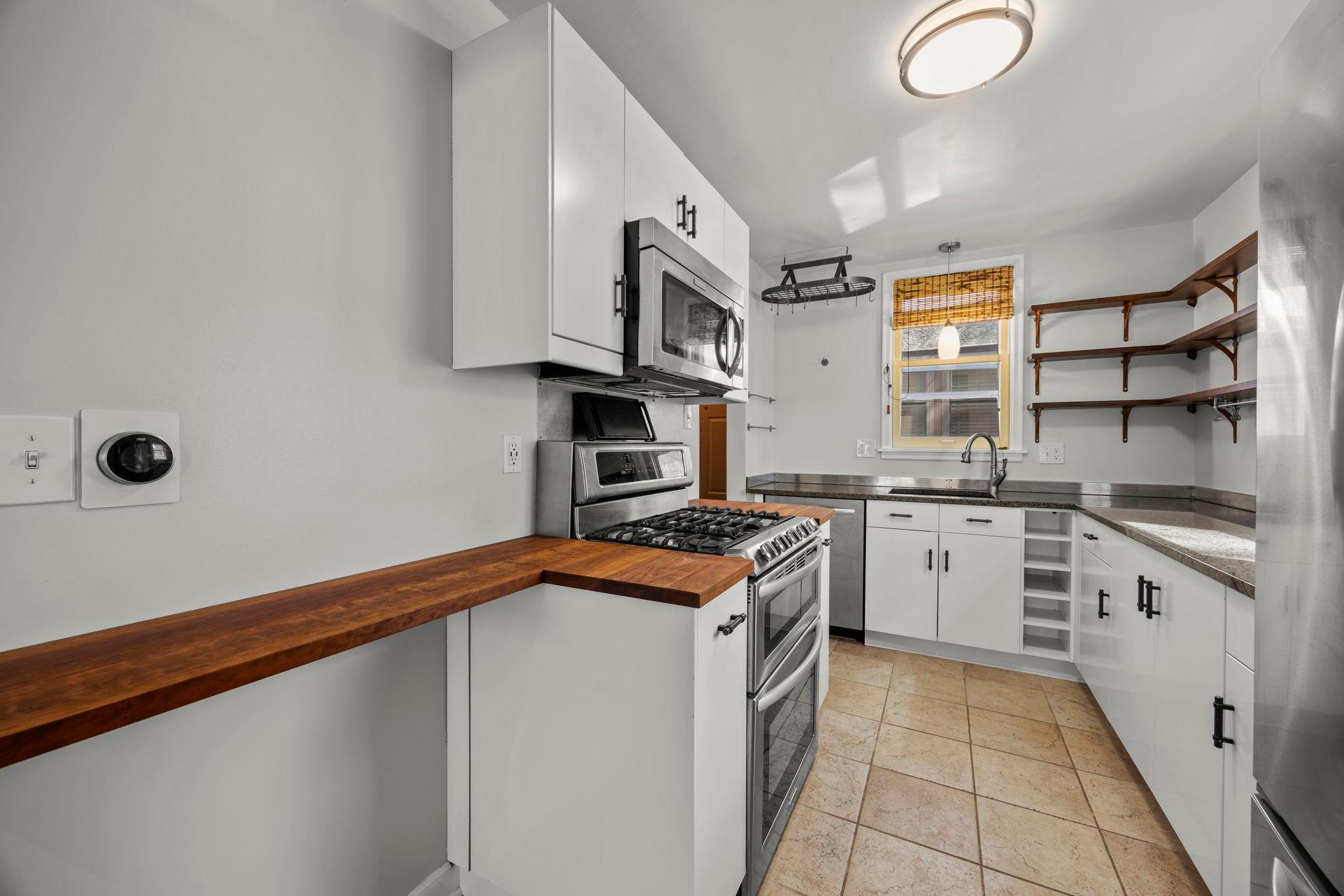 Open shelving above the cabinetry for added character and storage.