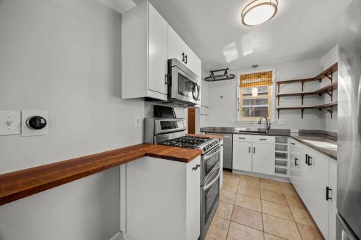 Open shelving above the cabinetry for added character and storage.