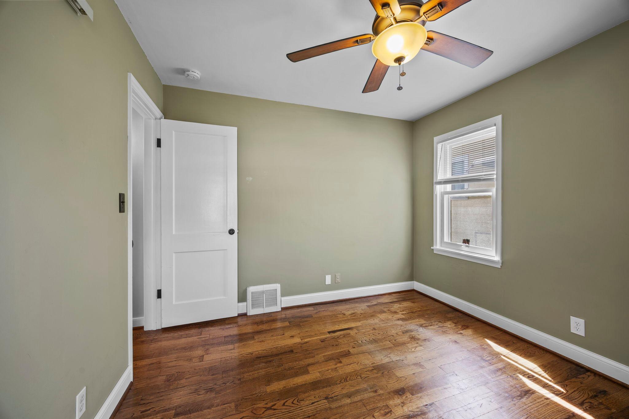 One of two main level bedrooms with side yard views.