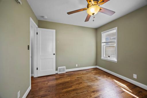 One of two main level bedrooms with side yard views.