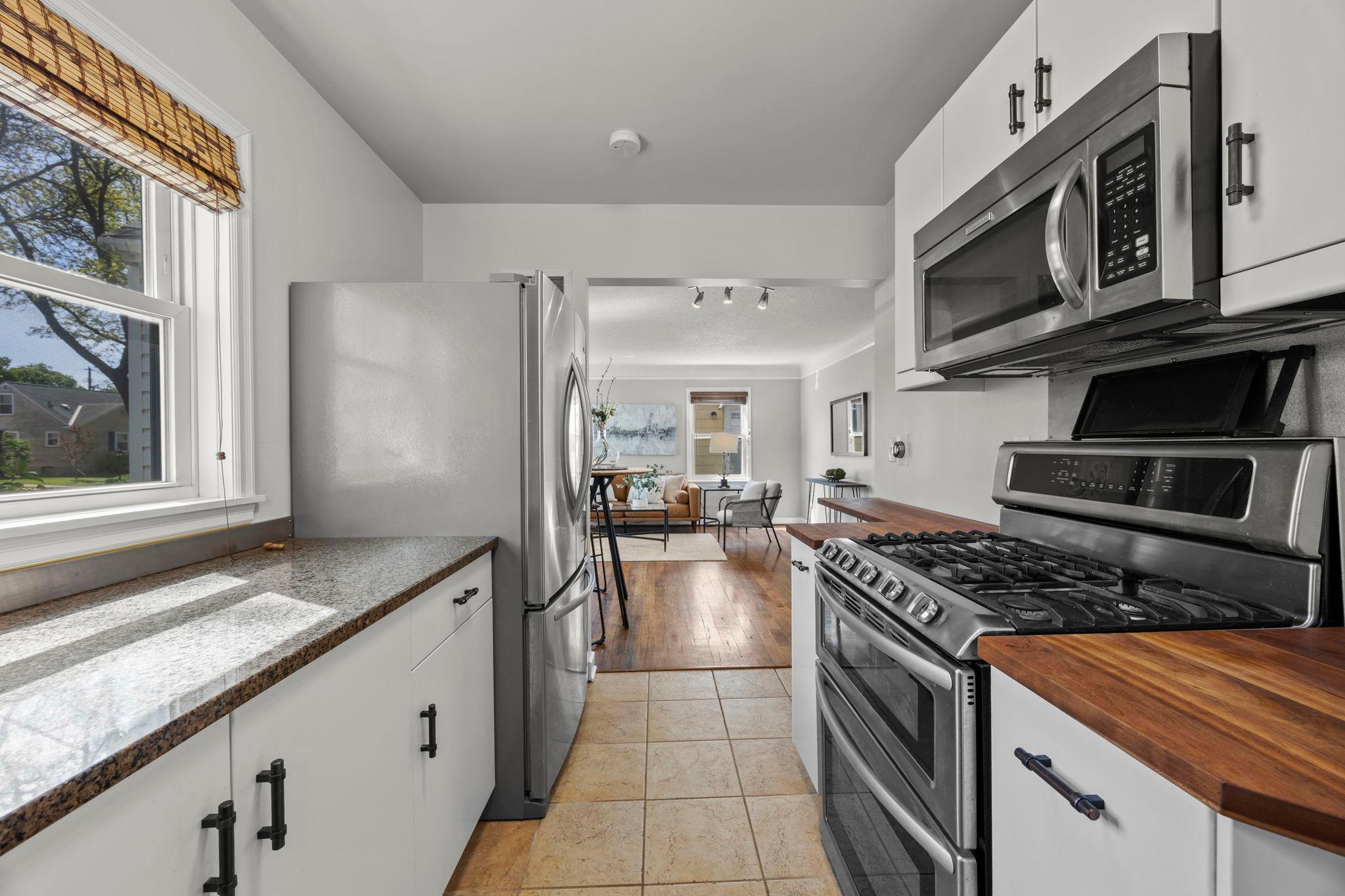 Kitchen features stainless steel appliances including a double oven and a gas stove.