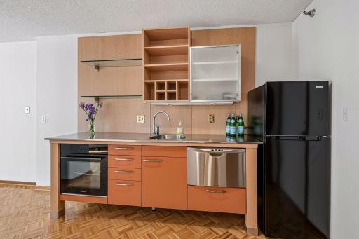 This efficiency unit has a smartly designed kitchenette including new oven, refrigerator and a compact dishwasher